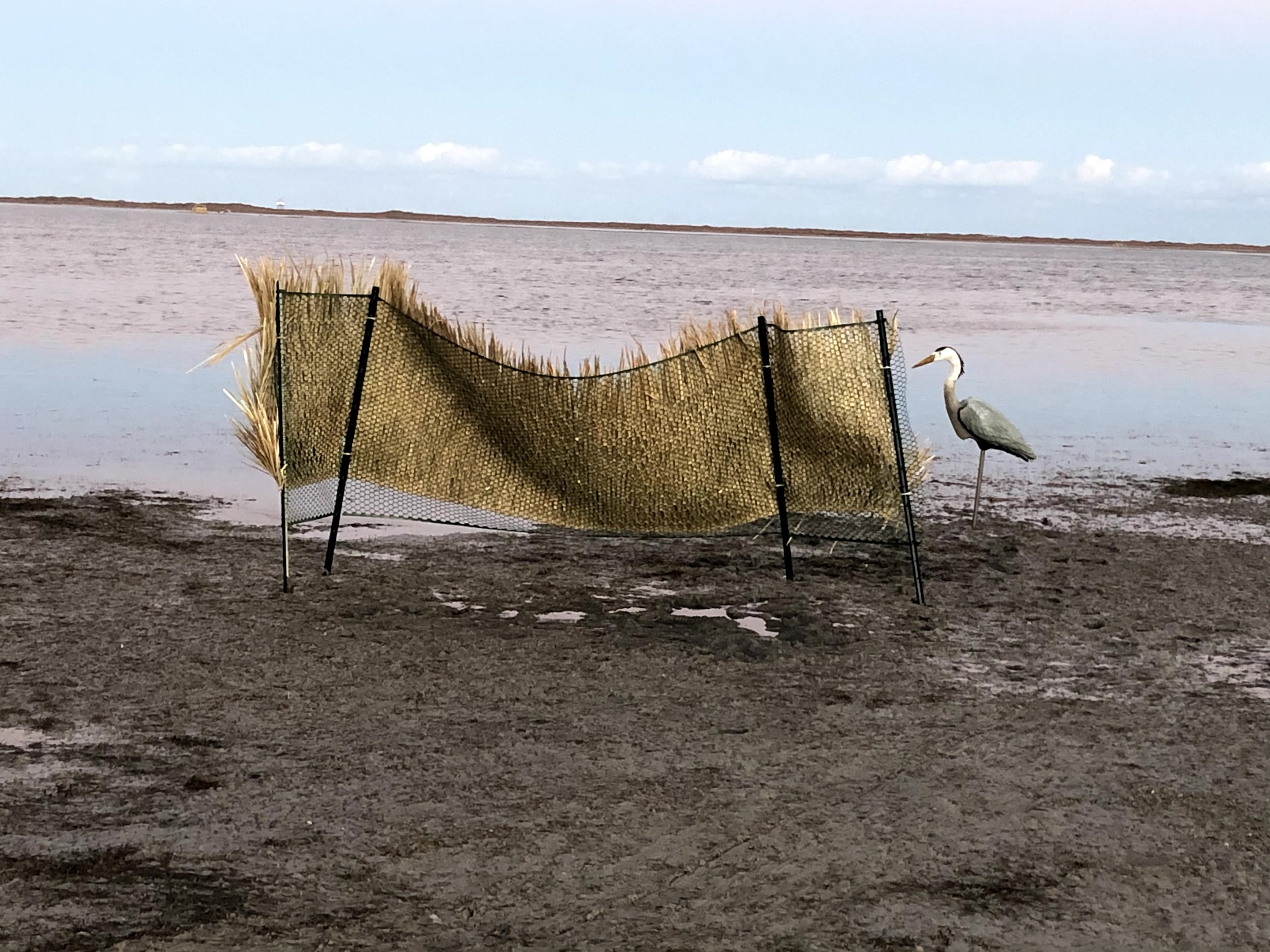 Portable duck blind on the edge of the water near sunset