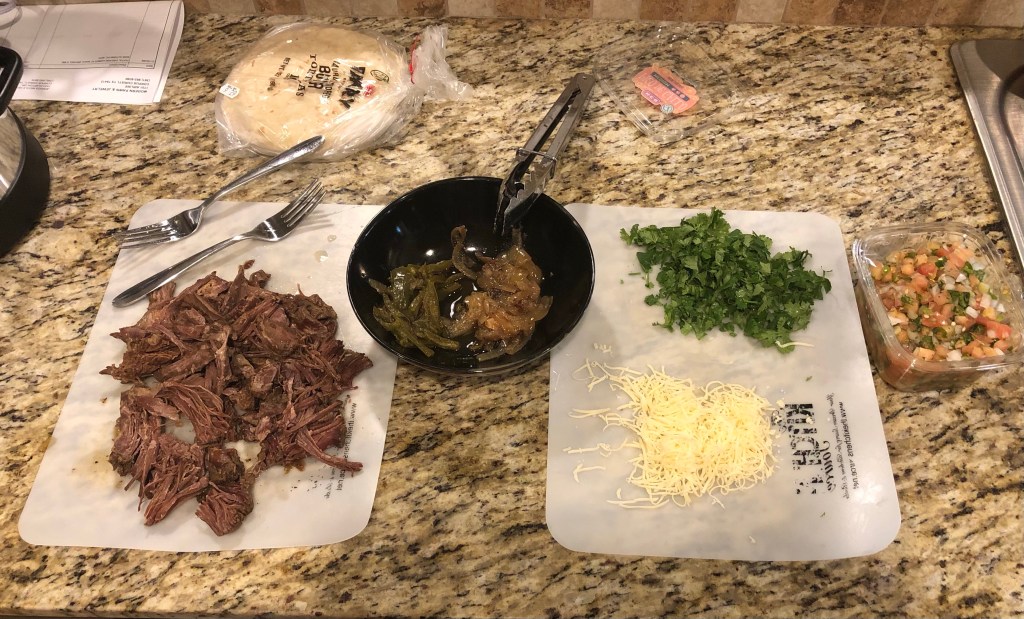 Buffet of shredded turkey meat, vegetables, cilantro, Queso Fresca, and Pico de Gallo
