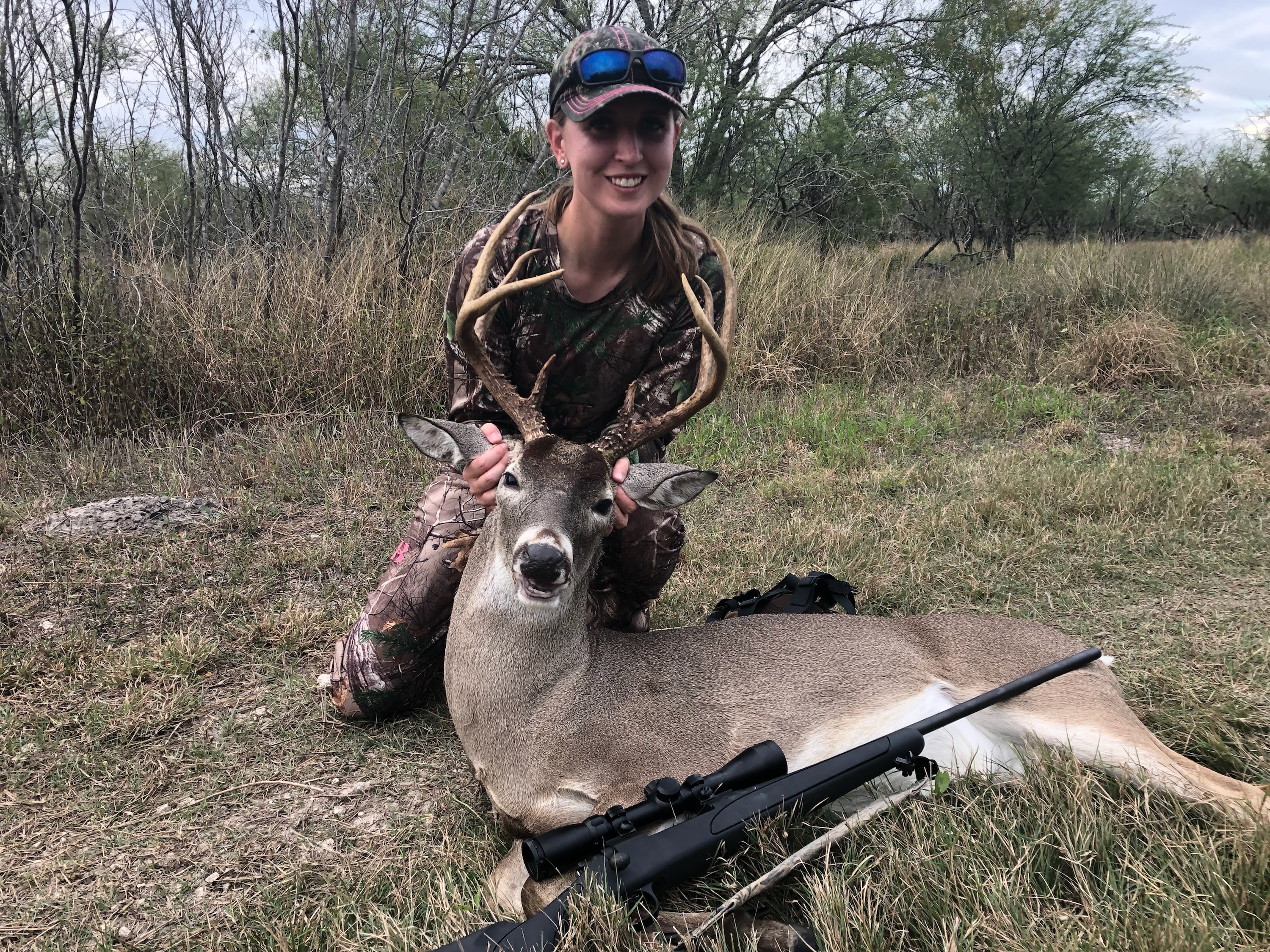 Jessica holding up large 8-point buck
