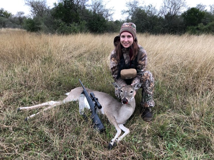 jessica with a whitetail doe in a field